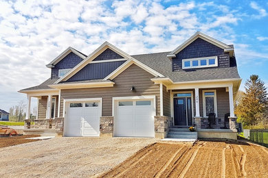 Inspiration for a small craftsman beige two-story concrete fiberboard exterior home remodel in Toronto with a shingle roof