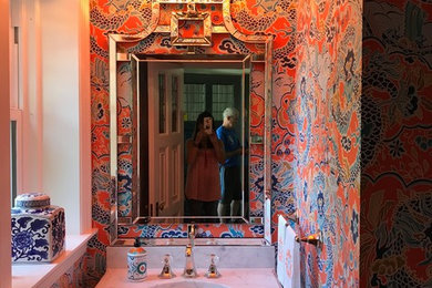Example of a zen powder room design in Boston with furniture-like cabinets, blue cabinets, a console sink and marble countertops