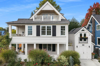 Large elegant white four-story wood exterior home photo in Seattle with a shingle roof and a gray roof
