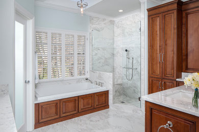 Photo of a large traditional master bathroom in Atlanta with raised-panel cabinets, dark wood cabinets, a drop-in tub, a two-piece toilet, white tile, porcelain tile, blue walls, porcelain floors, an undermount sink, engineered quartz benchtops, white floor, a corner shower and a hinged shower door.