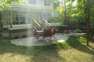 This is an example of a mid-sized traditional partial sun backyard stone outdoor basketball/tennis/multi-game court in Cincinnati for spring.