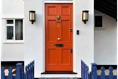 Entryway - victorian entryway idea in London with white walls and an orange front door