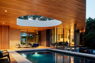 Large trendy indoor tile and rectangular natural and privacy pool photo in Other