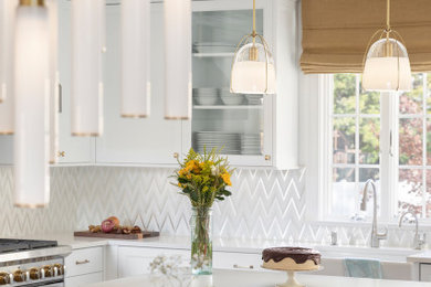 Example of a mid-sized transitional l-shaped light wood floor and beige floor eat-in kitchen design in New York with a farmhouse sink, shaker cabinets, white cabinets, quartz countertops, white backsplash, stainless steel appliances, an island and white countertops