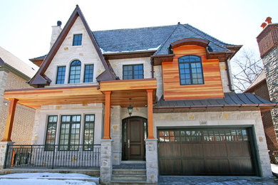 Example of a large classic multicolored two-story mixed siding gable roof design in Toronto