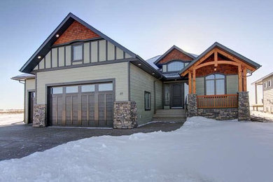 Inspiration for a timeless green three-story wood exterior home remodel in Calgary