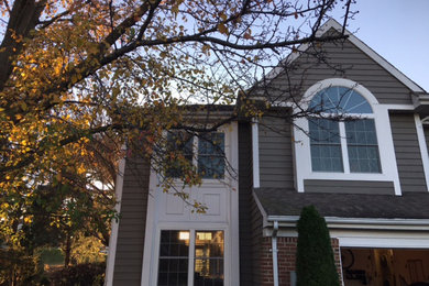 Inspiration for a mid-sized transitional gray two-story mixed siding exterior home remodel in Newark with a shingle roof