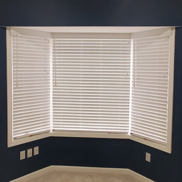 white blinds in bay and under arched windows
