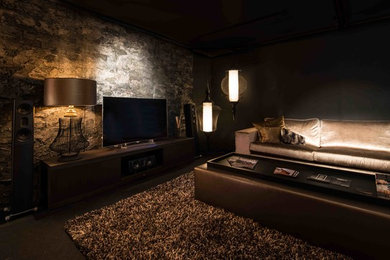 Living room - large transitional enclosed carpeted living room idea in Amsterdam with black walls and a wall-mounted tv