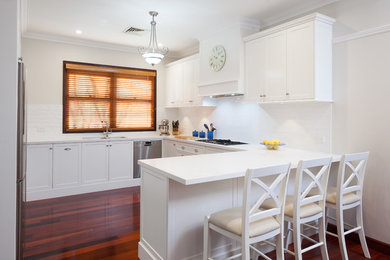 Inspiration for a modern kitchen in Perth with a double-bowl sink, shaker cabinets, white cabinets, quartz benchtops, white splashback, stainless steel appliances, ceramic splashback and white benchtop.