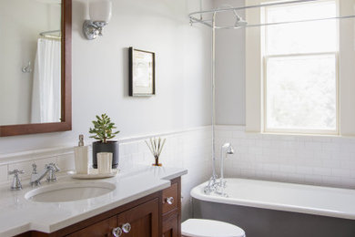 Mid-sized elegant master porcelain tile, gray floor and single-sink bathroom photo in Minneapolis with dark wood cabinets, a drop-in sink, white countertops and a freestanding vanity