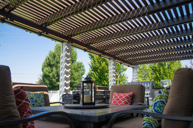 Large trendy backyard patio kitchen photo in Boise with a pergola