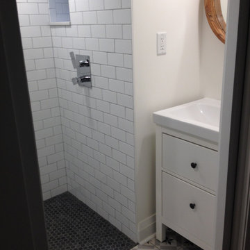 Small bathroom in a basement with low ceiling