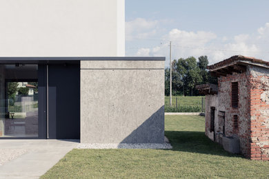 Idee per la villa grigia contemporanea a due piani di medie dimensioni con rivestimento in cemento