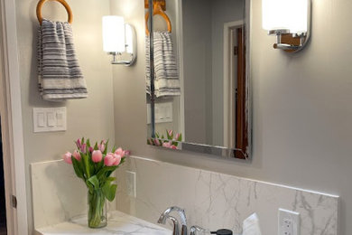 Small transitional kids' white tile and porcelain tile laminate floor, gray floor and single-sink bathroom photo in San Francisco with recessed-panel cabinets, white cabinets, a two-piece toilet, gray walls, an undermount sink, quartz countertops, white countertops, a niche and a built-in vanity