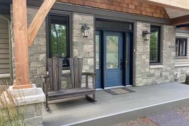 This is an example of a small modern front porch design in Toronto.