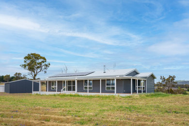 Photo of a country home design in Central Coast.