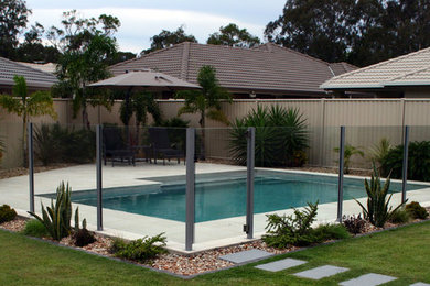 Design ideas for a mid-sized contemporary home design in Brisbane.