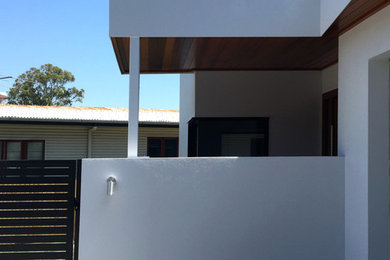 This is an example of a modern concrete grey exterior in Brisbane with a flat roof.