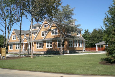 Inspiration for a large timeless brown two-story wood gable roof remodel in New York
