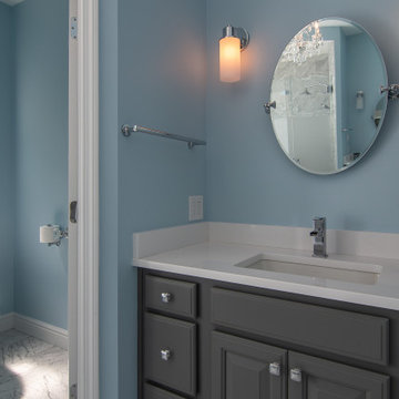 Traditional master bath utilizing frosted and clear glass to allow for needed pr