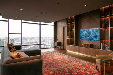 Living room - mid-sized open concept medium tone wood floor, brown floor and wood wall living room idea in Nashville with brown walls and a wall-mounted tv