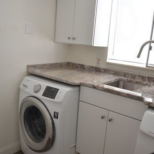 Small contemporary single-wall separated utility room in Detroit with a single-bowl sink, flat-panel cabinets, white cabinets, granite worktops, plywood flooring and a side by side washer and dryer.