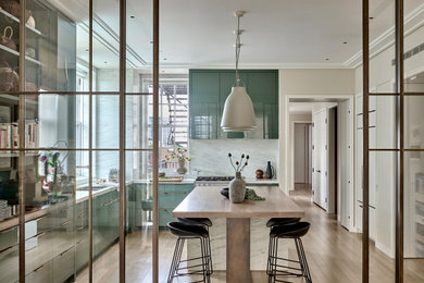 Large trendy single-wall light wood floor kitchen pantry photo in Chicago with an undermount sink, flat-panel cabinets, green cabinets, marble countertops, white backsplash, stone slab backsplash, colored appliances, an island and white countertops