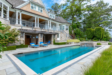 Large elegant two-story house exterior photo in Other