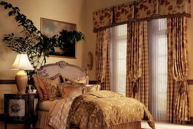 Design ideas for a mid-sized traditional master bedroom in Charlotte with beige walls.