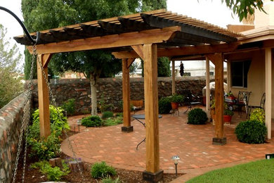 Example of a classic backyard brick patio design in Austin with a pergola