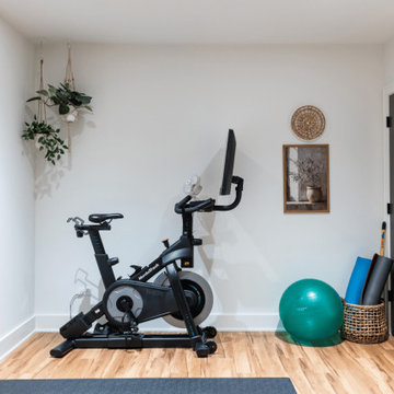 Bright Basement Fitness Room with Light Wood Flooring