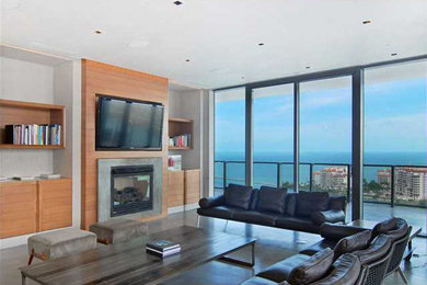 Photo of a mid-sized living room in Miami with white walls and a wall-mounted tv.