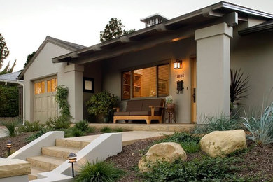 Mid-sized arts and crafts beige one-story stucco exterior home photo in Santa Barbara with a hip roof