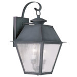 Livex Lighting - Mansfield Outdoor Wall Lantern, Charcoal - Illuminate a driveway or terrace area with the Mansfield Wall Lantern. Modeled on traditional, Victorian-style lamps, it features a bronze shade with seeded glass panels suspended from a curved mount. The lantern is weatherproof and makes an elegant addition to an exterior wall or porch.