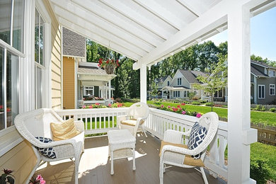 Inspiration for a large arts and crafts front yard verandah in Indianapolis with a roof extension.