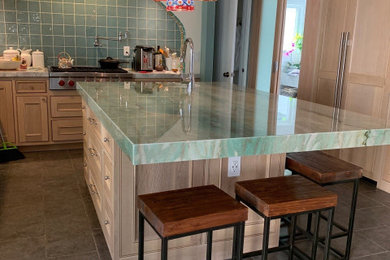 Eat-in kitchen - eclectic l-shaped porcelain tile and gray floor eat-in kitchen idea in Orange County with an undermount sink, light wood cabinets, quartzite countertops, green backsplash, ceramic backsplash, an island and turquoise countertops