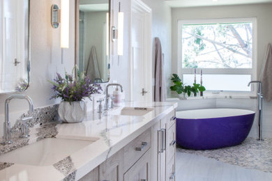 Mid-sized beach style master white tile and porcelain tile ceramic tile, gray floor and double-sink bathroom photo in San Diego with shaker cabinets, light wood cabinets, a one-piece toilet, gray walls, an undermount sink, quartz countertops, a hinged shower door, white countertops and a built-in vanity