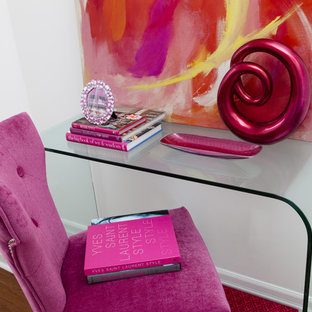 Inspiration for a medium sized modern home office and library in Toronto with white walls, medium hardwood flooring, no fireplace, a freestanding desk and brown floors.