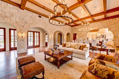Living room - huge rustic medium tone wood floor living room idea in Austin