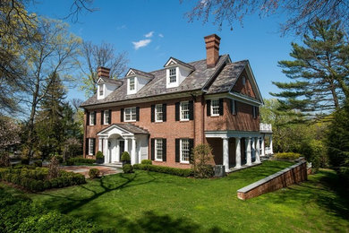Large elegant two-story brick gable roof photo in New York