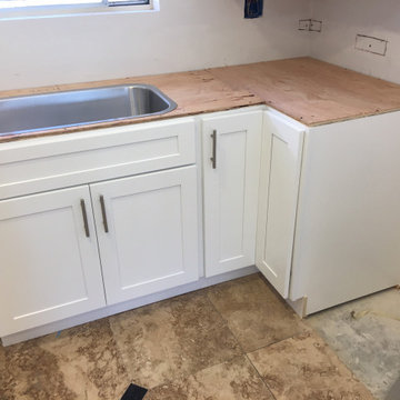 White shaker kitchen cabinets with Sparking white quartz countertops