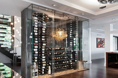 Wine cellar - small 1960s dark wood floor wine cellar idea in Miami