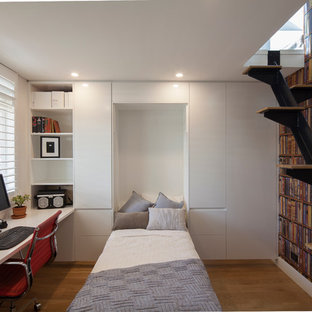 Small modern home office and library in Sydney with a built-in desk, white walls, medium hardwood flooring and no fireplace.