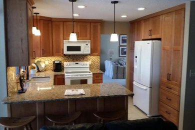 Open concept kitchen - mid-sized transitional u-shaped ceramic tile and beige floor open concept kitchen idea in Other with a double-bowl sink, shaker cabinets, light wood cabinets, granite countertops, beige backsplash, mosaic tile backsplash, white appliances and a peninsula