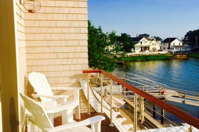 Example of a small balcony design in New York with a roof extension