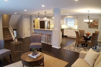Inspiration for a transitional kitchen remodel in Milwaukee with white cabinets, stainless steel appliances and an island