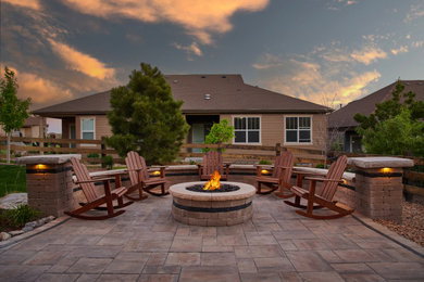 Mid-sized trendy backyard concrete paver patio photo in Denver with a fire pit and no cover