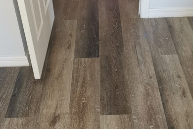 Example of a classic vinyl floor and brown floor hallway design in Tampa