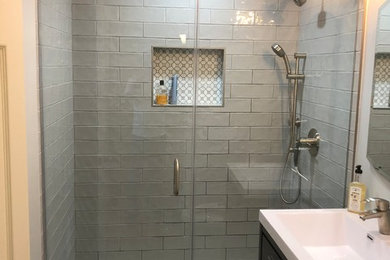 Inspiration for a small modern gray tile and cement tile mosaic tile floor bathroom remodel in Los Angeles with brown cabinets, marble countertops, flat-panel cabinets and an integrated sink